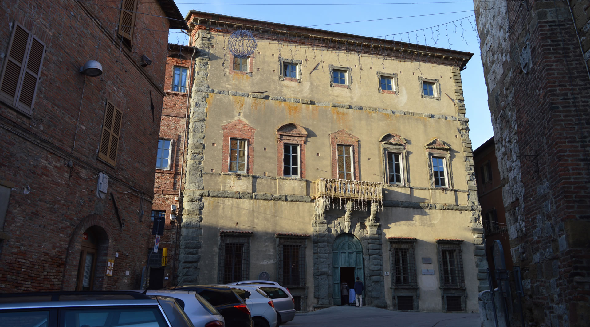 View of the main facade of Palazzo della Corgna, characterized by elegant relief decorations in pietra serena that enhance the historic building.