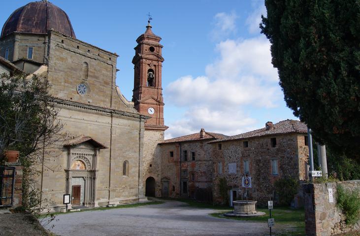 Front view of the Sanctuary of Madonna di Mongiovino with the sanctuary in the foreground and the bell tower in the background.