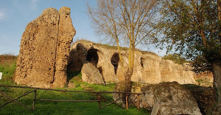 Monumental remains of the great substructures of Ocriculum, with arches carved into the rock and surrounding vegetation