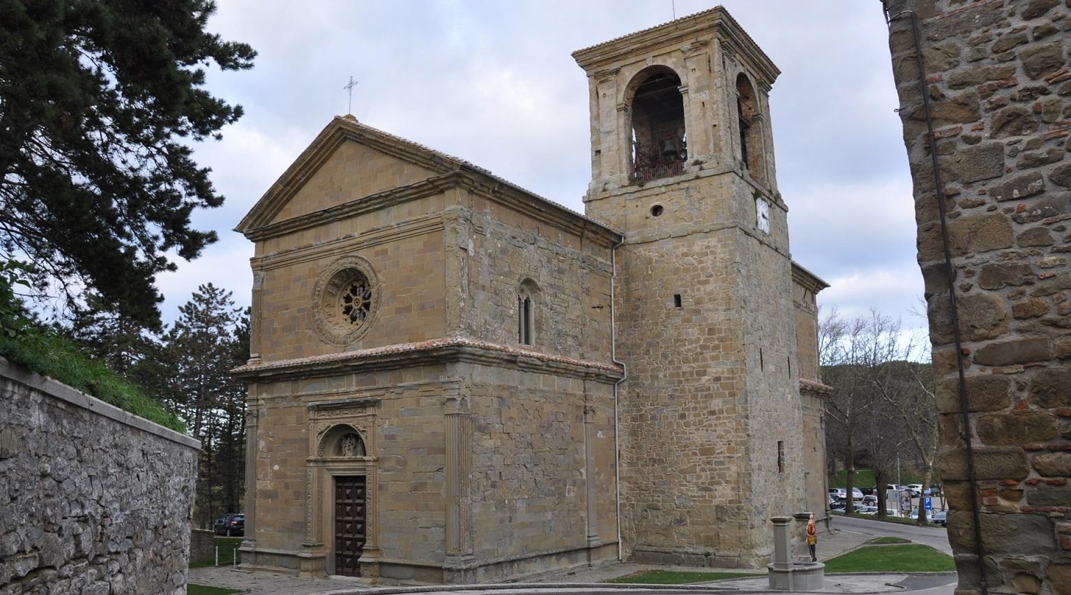 Panoramic view of the exterior of the Sanctuary of Madonna dei Miracoli, with the bell tower standing next to the building, adding a vertical element to the structure.