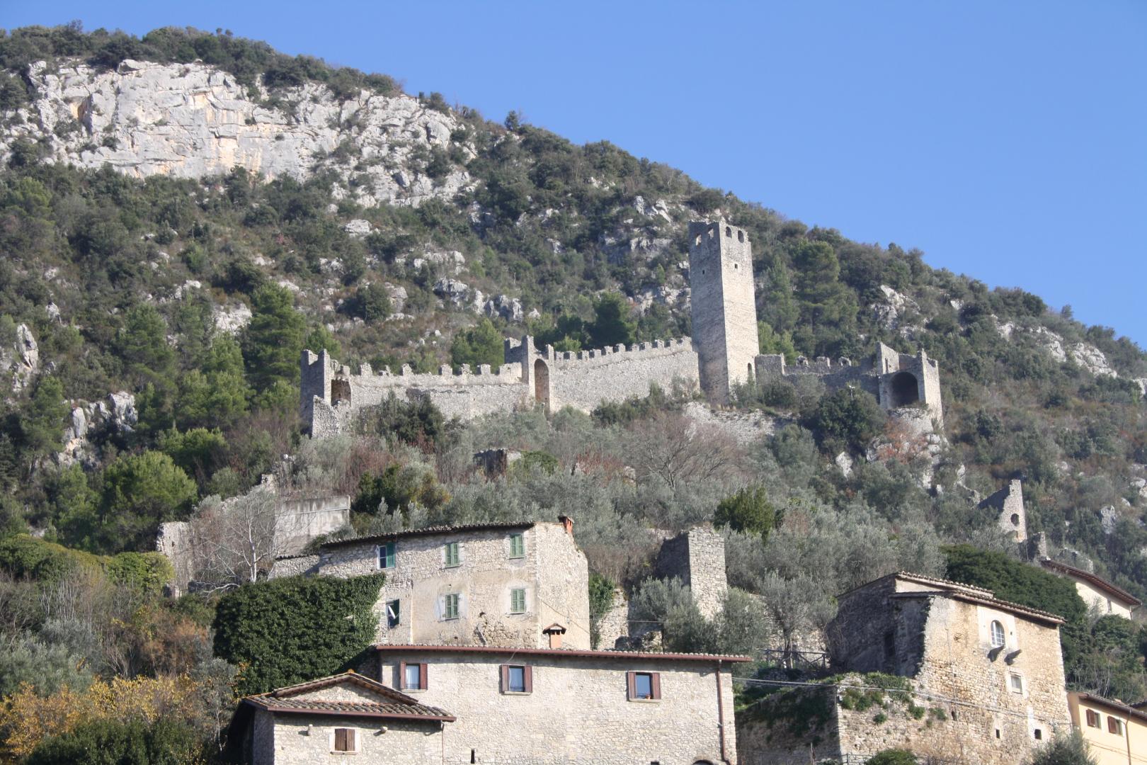 The Rocca of Ferentillo overlooking the village, with medieval walls and a tower on a rocky slope in the Valnerina.