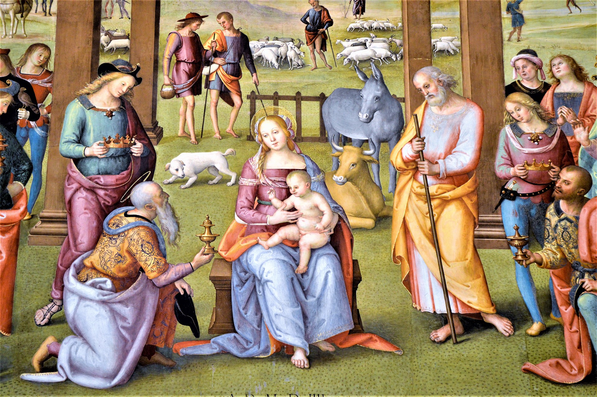 Fresque représentant l'Adoration des Mages avec la Vierge, l'Enfant Jésus, Saint Joseph et divers personnages dans un paysage pastoral.