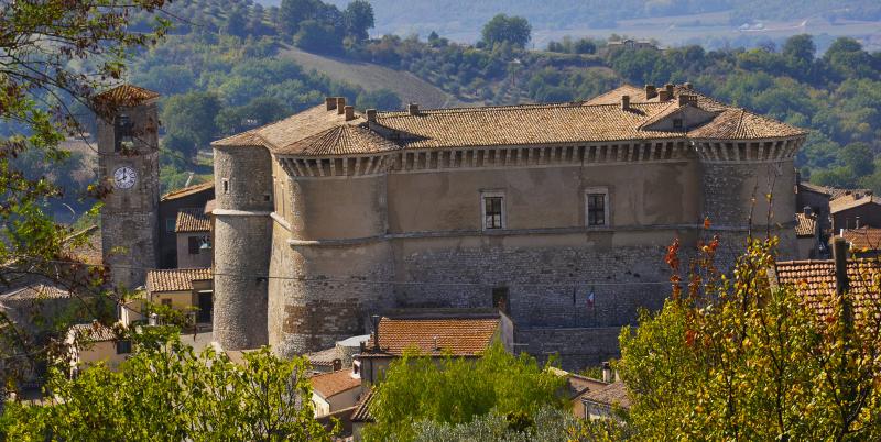 View of the Rocca of Alviano, a majestic medieval fortress surrounded by the village and the Umbrian hills.