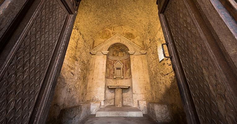 Interior of the Temple of Clitumnus, with doors opening into the apse, where a small altar is present