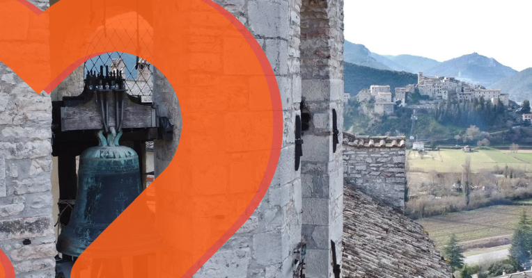 Panorama of Arrone with a stone bell tower in the foreground and the hilltop village in the background, with an orange heart.
