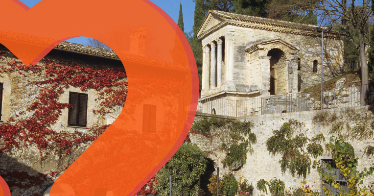 View of the Tempietto del Clitunno among vegetation and stone walls in Campello sul Clitunno.