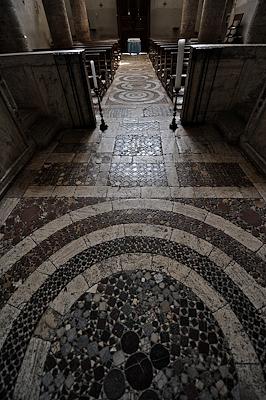 Floor decoration of the Church of Santa Maria Assunta, with geometric motifs in Cosmatesque style in polychrome marble.