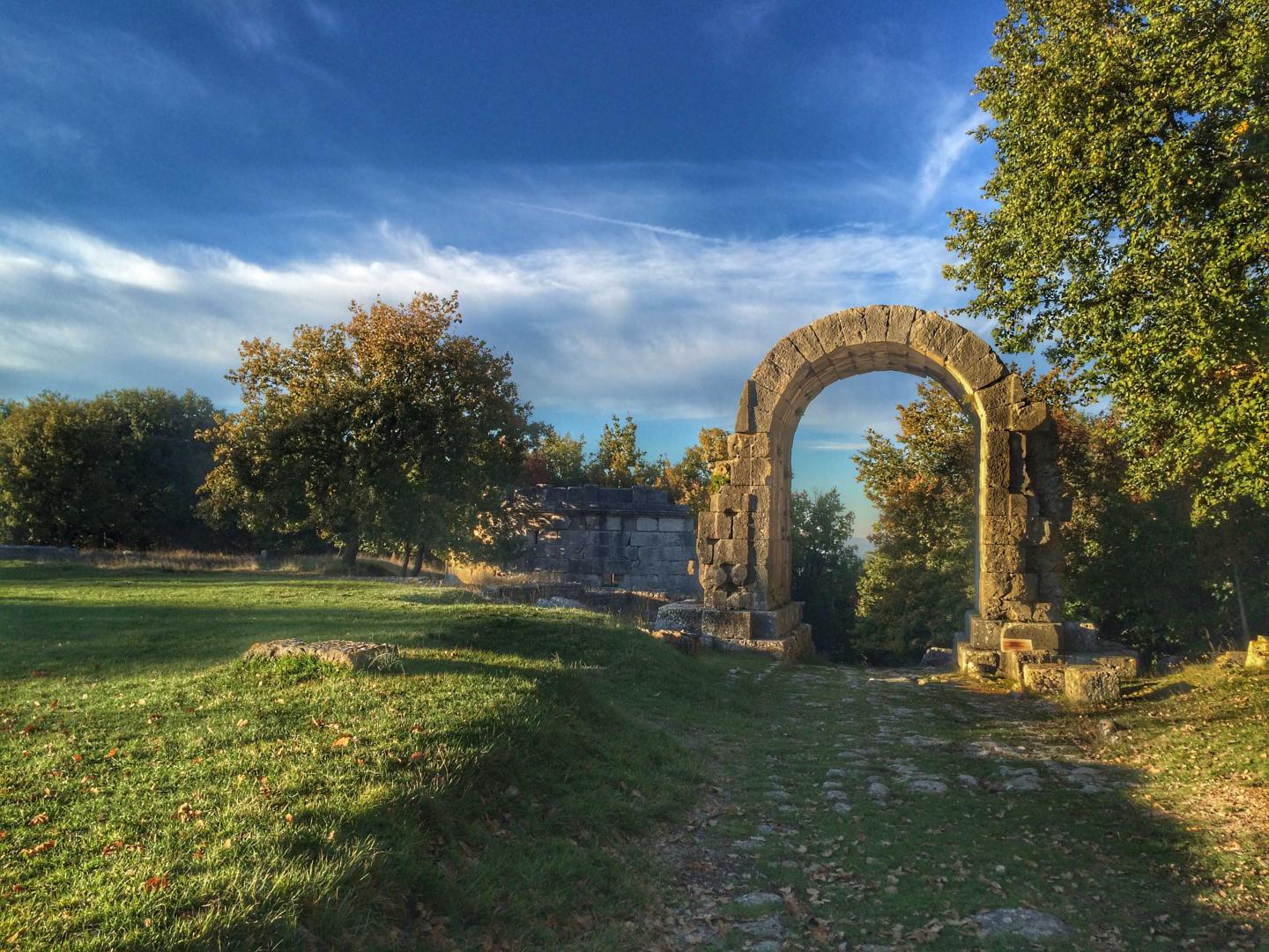 Arch of San Damiano with cobblestones of the Via Flaminia