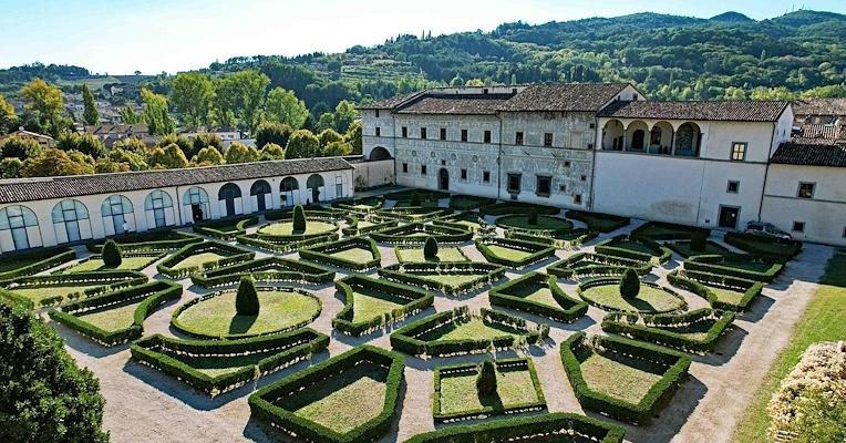Aerial view of the Italian-style garden with geometric hedges and Palazzo Vitelli alla Cannoniera in the background, in Città di Castello
