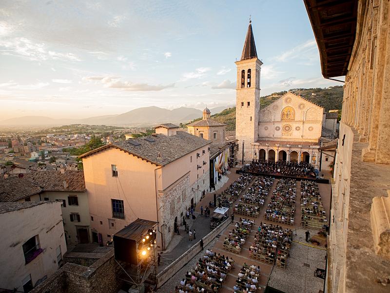 Panoramic view of Piazza Duomo in Spoleto during the Festival of Two Worlds, with the audience seated in front of the stage set at the foot of the cathedral.